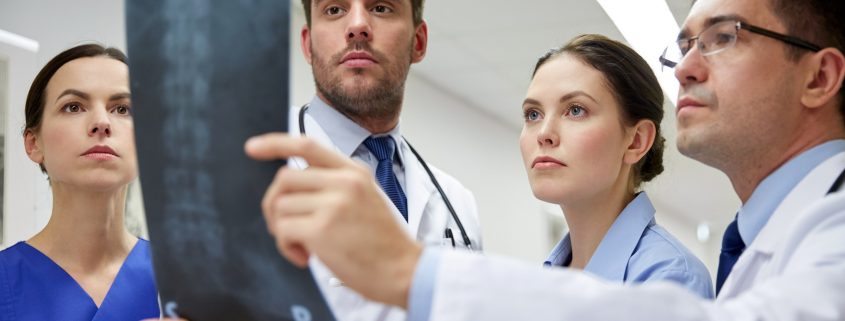group of doctors looking at x-ray scan image
